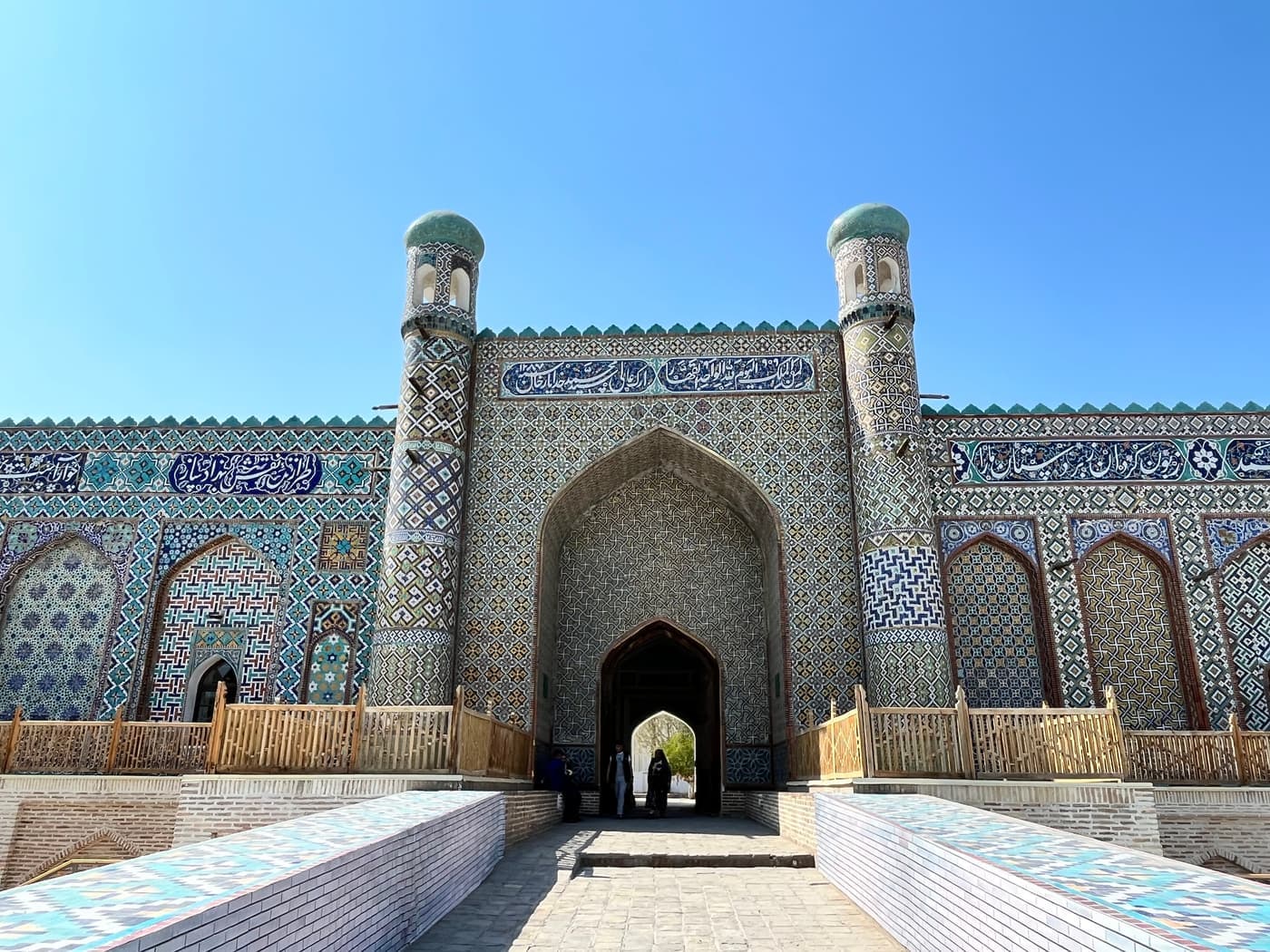 The entrance gate of the palace between two tiled towers, seen from the ramp
