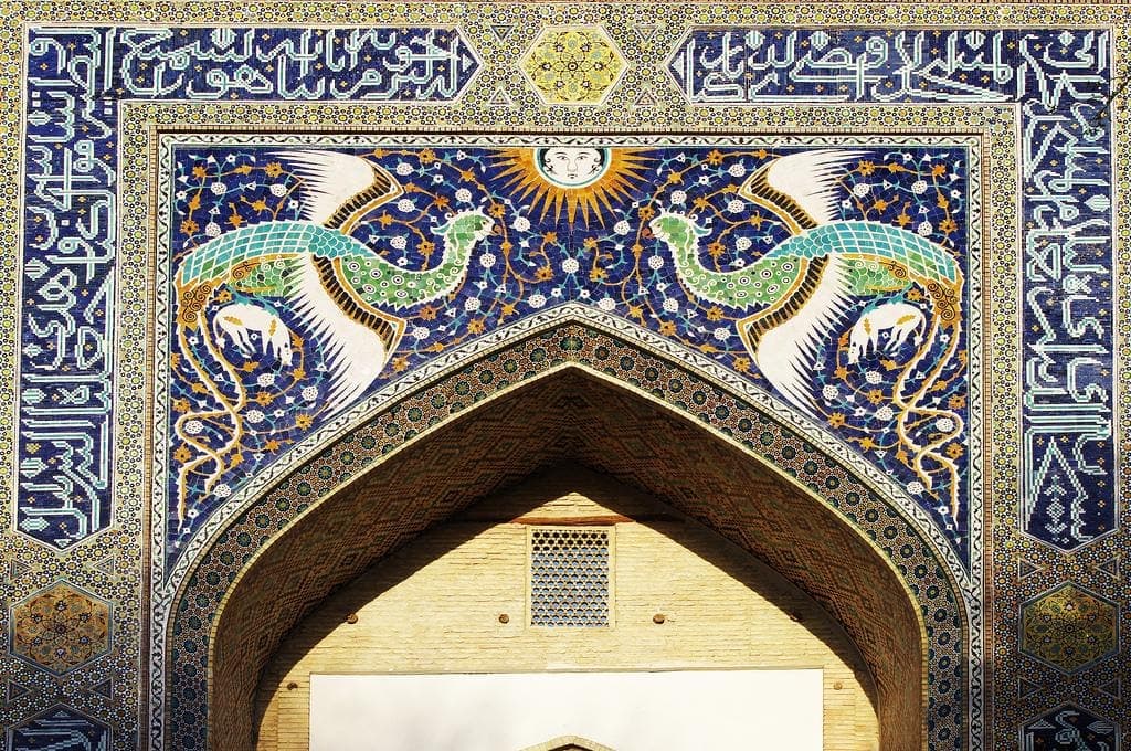 The two simurgh birds flanking a sun face on the portal