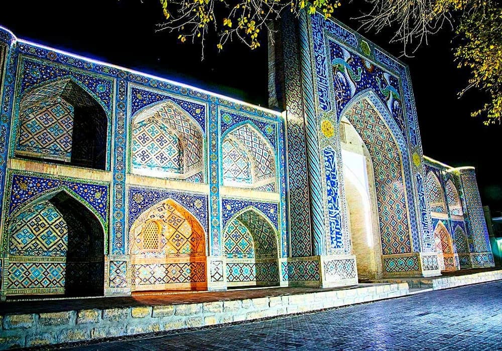 The madrasah floodlit after dark